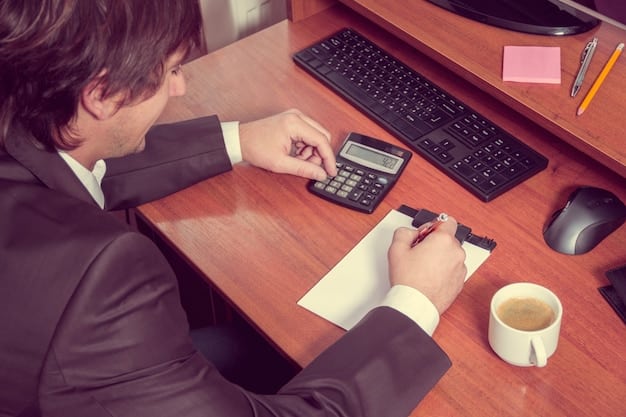 A person using a calculator and reviewing financial documents at a desk, emphasizing the importance of calculating and strategizing 401(k) contributions for maximizing savings by the end of 2025.