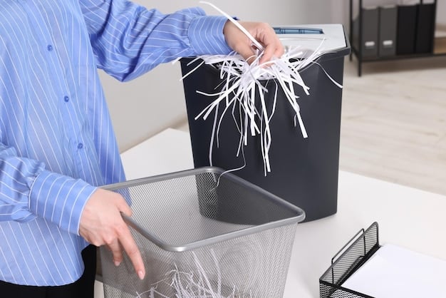 A person shredding documents with a cross-cut shredder, emphasizing the importance of destroying sensitive information.