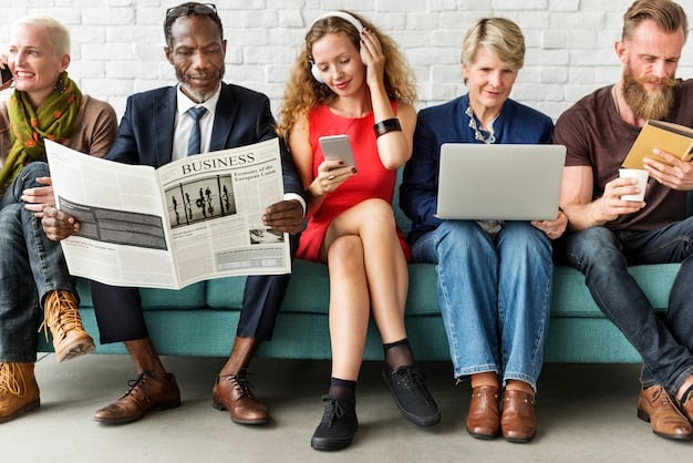 A diverse group of people participating in a workshop about identifying fake news, with laptops and informational posters visible in the background.
