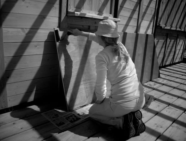 A close-up of a worker installing insulation in an attic, showcasing the tangible improvements made possible by the weatherization grant.