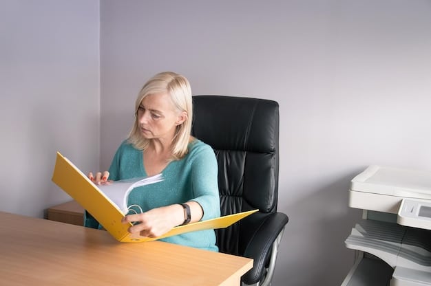 A person sitting at a desk reviewing Social Security documents with a concerned expression, highlighting the challenges of understanding and managing disability benefits.