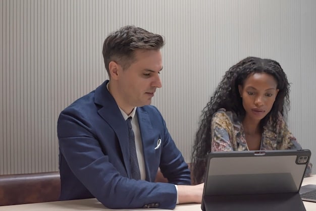 A career counselor advising a young adult on potential job training programs, using a computer to access information. The scene highlights the importance of personalized guidance in navigating federal job training opportunities.