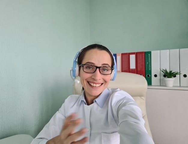 A person wearing a headset, providing telehealth services via video call. The person is smiling and engaging with the patient on the screen, demonstrating the convenience and accessibility of remote healthcare. The background is a professional and calming home office setting.