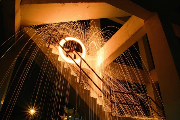 A construction worker welding a steel beam on a high-rise building, with sparks flying and safety gear on, symbolizing the essential role of skilled trades in construction and infrastructure.