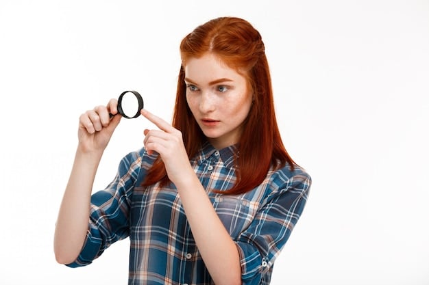 A person uses a magnifying glass to carefully examine a company's website on a laptop screen, focusing on the 