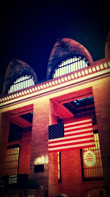 A close-up photograph of the US Supreme Court building during sunrise, highlighting the architectural details and the American flag waving in the background.
