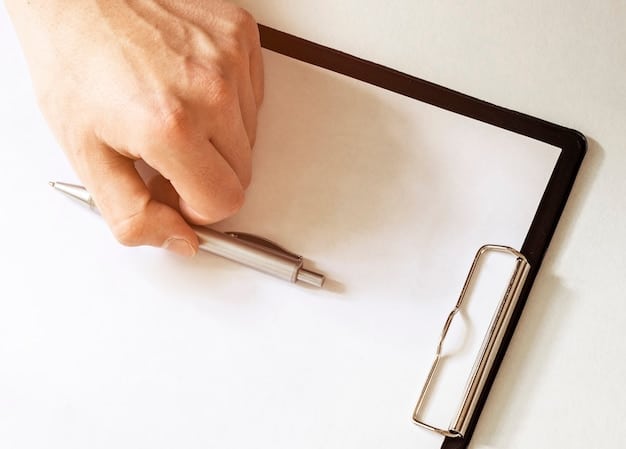 A close-up of a hand holding a pen and signing a document labeled 
