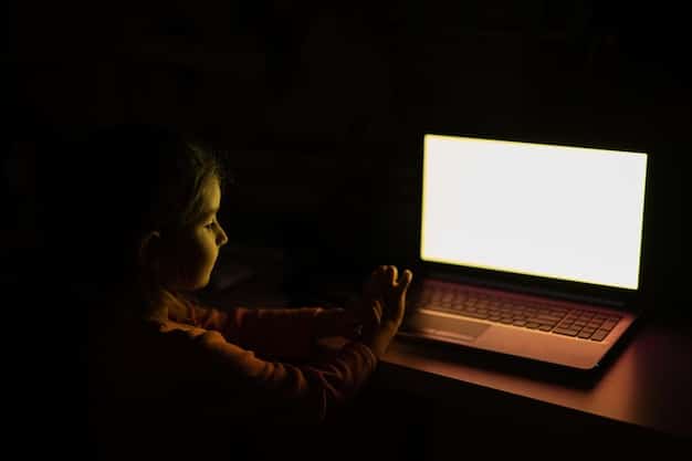 A person sitting at a desk with their face partially obscured by a laptop screen displaying lines of code and privacy policy text. The lighting is soft and creates a sense of concern or introspection.